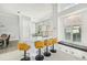 Bright kitchen featuring white cabinets, a large island, bar seating, and a cozy window bench at 7217 Churston Ln, University Park, FL 34201