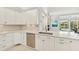 Kitchen area featuring white cabinets, stainless steel appliances, and a sleek countertop with stainless steel sink at 7217 Churston Ln, University Park, FL 34201