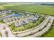 Aerial view of a neighborhood with houses and a lake at 8370 Velda Trl, Sarasota, FL 34241