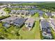 Aerial view of a community with houses, a lake, and lush greenery at 8370 Velda Trl, Sarasota, FL 34241