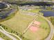 Aerial view of community with sports fields and a clubhouse at 8370 Velda Trl, Sarasota, FL 34241