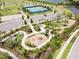 Aerial view of community amenities, including tennis courts and playground at 8370 Velda Trl, Sarasota, FL 34241