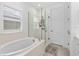 Bathroom with soaking tub and walk-in shower at 8370 Velda Trl, Sarasota, FL 34241