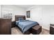 Bedroom with blue bedding and a small ottoman at 8370 Velda Trl, Sarasota, FL 34241