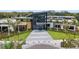 Modern clubhouse entrance with landscaping and palm trees at 8370 Velda Trl, Sarasota, FL 34241