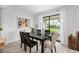 Dining room with dark brown table, beige chairs, and access to the backyard at 8370 Velda Trl, Sarasota, FL 34241