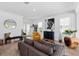 Bright living room with a yellow armchair, gray sofa, and wooden coffee table at 8370 Velda Trl, Sarasota, FL 34241