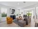 Open-concept living and dining area with gray sofa and wooden coffee table at 8370 Velda Trl, Sarasota, FL 34241