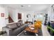 Living room with gray sofa, yellow accent chair, and entryway view at 8370 Velda Trl, Sarasota, FL 34241