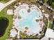 Large resort-style pool with surrounding lounge chairs and landscaping at 8370 Velda Trl, Sarasota, FL 34241