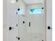 Modern shower with frameless glass enclosure and black fixtures at 2246 Webber St, Sarasota, FL 34239