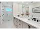 Bathroom with double vanity, quartz countertop and black accents at 2246 Webber St, Sarasota, FL 34239