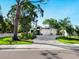 Modern house with white exterior, three-car garage, and landscaped yard at 2246 Webber St, Sarasota, FL 34239