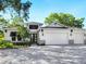 Modern two-story house with white exterior, three car garage, and paver driveway at 2246 Webber St, Sarasota, FL 34239