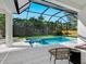 Relaxing pool and spa area with screened enclosure, lounge chairs, and patio furniture at 2246 Webber St, Sarasota, FL 34239