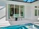 Enjoy this view from the pool area with two chairs and a small table at 2246 Webber St, Sarasota, FL 34239