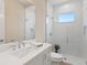 Modern bathroom with white cabinets, a glass shower, and a large mirror at 2319 Webber St, Sarasota, FL 34239