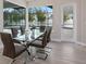 Bright dining room with glass table and chairs, looking out to the pool area at 2319 Webber St, Sarasota, FL 34239