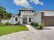 Two-story home with modern design, landscaped yard, and paver driveway at 2319 Webber St, Sarasota, FL 34239