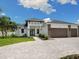 Modern two-story house with a three-car garage and a paver driveway at 2319 Webber St, Sarasota, FL 34239