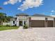 Modern two-story house with a three-car garage and a paver driveway at 2319 Webber St, Sarasota, FL 34239