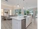 Open kitchen with white cabinetry, stainless steel appliances, and island overlooking the living room at 2319 Webber St, Sarasota, FL 34239