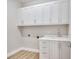 Laundry room with white cabinets and a built-in sink at 2319 Webber St, Sarasota, FL 34239