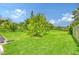 Large grassy backyard with mature trees at 2488 Breakwater Cir, Sarasota, FL 34231