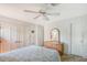 Spacious bedroom with a queen bed, dresser, and mirrored closet doors at 2488 Breakwater Cir, Sarasota, FL 34231