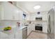 Modern kitchen with stainless steel appliances and white cabinets at 2488 Breakwater Cir, Sarasota, FL 34231