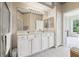 Bathroom with double sinks, a large shower and white cabinets at 4951 Lakescene Pl, Sarasota, FL 34243