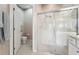 Bathroom with shower, toilet, and white cabinets at 4951 Lakescene Pl, Sarasota, FL 34243