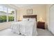 Main bedroom with king bed, nightstands, and large window at 4951 Lakescene Pl, Sarasota, FL 34243