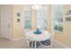 Cozy breakfast nook with white table and blue chairs at 4951 Lakescene Pl, Sarasota, FL 34243