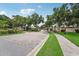 Brick-paved entrance to the community with lush landscaping at 4951 Lakescene Pl, Sarasota, FL 34243