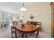 Bright dining room with an oval table and view into the living room at 4951 Lakescene Pl, Sarasota, FL 34243