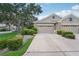 Two-car garage and manicured landscaping at 4951 Lakescene Pl, Sarasota, FL 34243