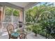 Screened-in patio with outdoor grill and lush tropical landscaping at 4951 Lakescene Pl, Sarasota, FL 34243