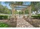 Relaxing pool area with pergola and brick pathway at 4951 Lakescene Pl, Sarasota, FL 34243