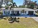 Charming single-story home boasts a well-maintained lawn, and fresh landscaping at 2420 Foster Ln, Sarasota, FL 34239