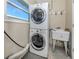 Laundry room with stackable washer and dryer and utility sink at 2420 Foster Ln, Sarasota, FL 34239