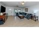 Bright living room featuring a comfy sectional sofa and tile floors at 2420 Foster Ln, Sarasota, FL 34239