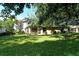 Backyard with grassy area and screened patio at 4072 Fairway Pl, North Port, FL 34287