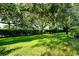 Large backyard with shaded lawn and hedges at 4072 Fairway Pl, North Port, FL 34287