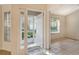 Bright and airy entryway with tile floors and a view of the backyard at 4072 Fairway Pl, North Port, FL 34287