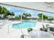 Community pool with lounge chairs and shaded seating at 4072 Fairway Pl, North Port, FL 34287