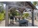 Outdoor kitchen and dining area under a pergola with a grill and bar seating at 4108 101St W St, Bradenton, FL 34210