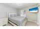 Bright bedroom with a striped comforter and flat-screen TV at 5975 Hagerman Rd, Sarasota, FL 34232