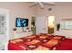 Main bedroom with king bed, TV, and access to bathroom at 6772 Greenview Ln, Englewood, FL 34224