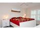 Spacious bedroom with king-size bed, dresser, and large window at 6772 Greenview Ln, Englewood, FL 34224